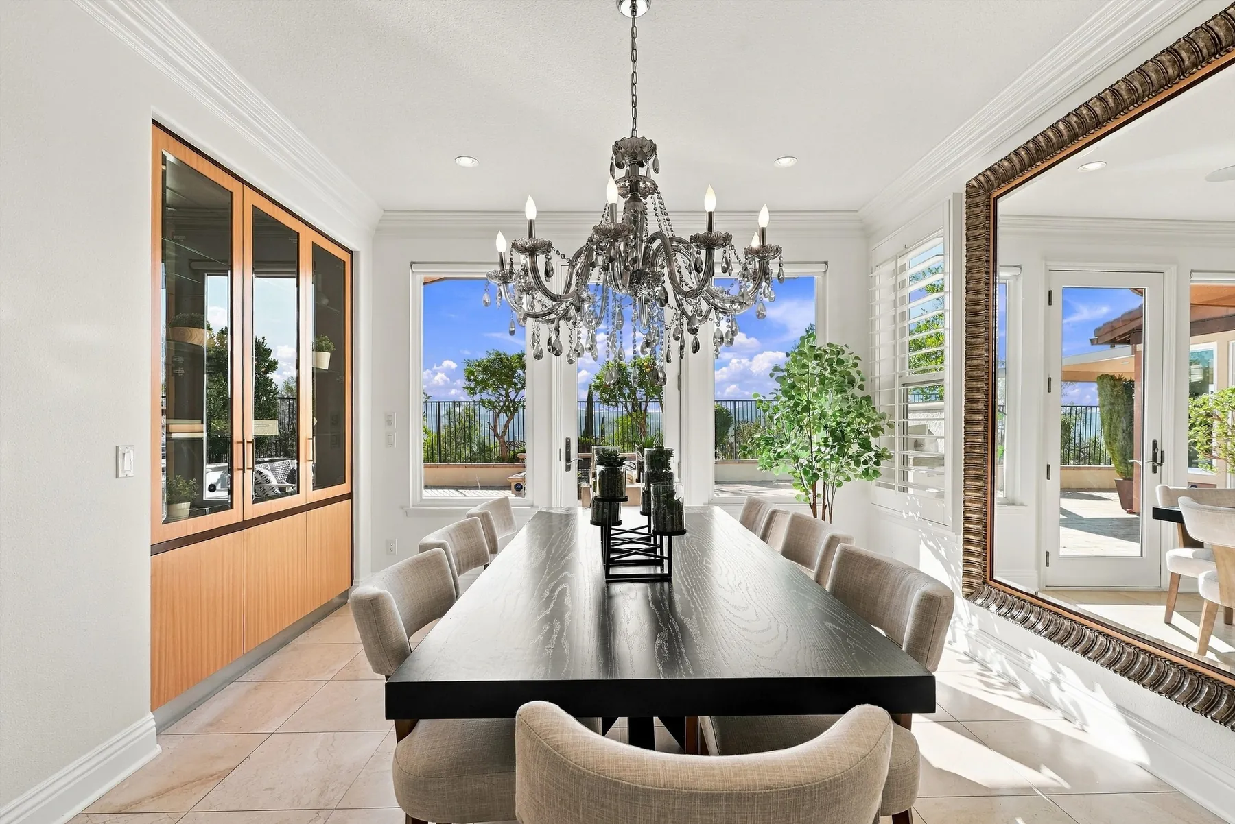 Formal dining room with chandelier and built-in display cabinetry